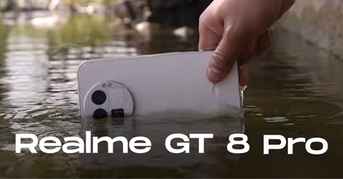 Realme GT 8 Pro Launched: A hand holding a white Realme GT 8 Pro partially submerged in water, showing its rear camera design and water-resistant capability